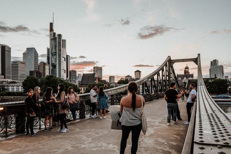 People on the Eiserner Steg with Frankfurt skyscrapers behind