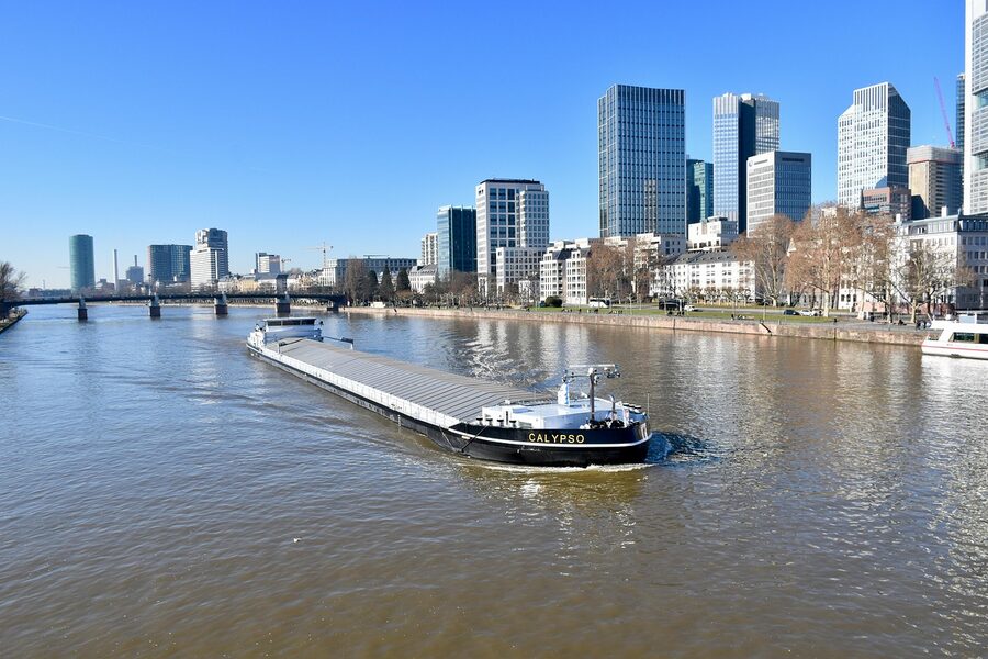 Frankfurt River Main with working boat and skyline
