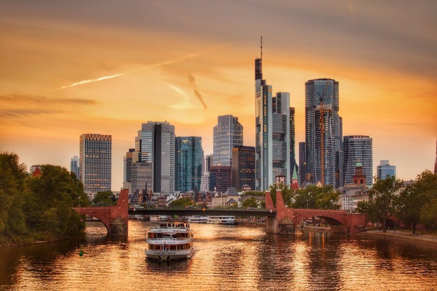 Frankfurt skyline at sunset with sightseeing boat cruising the Main