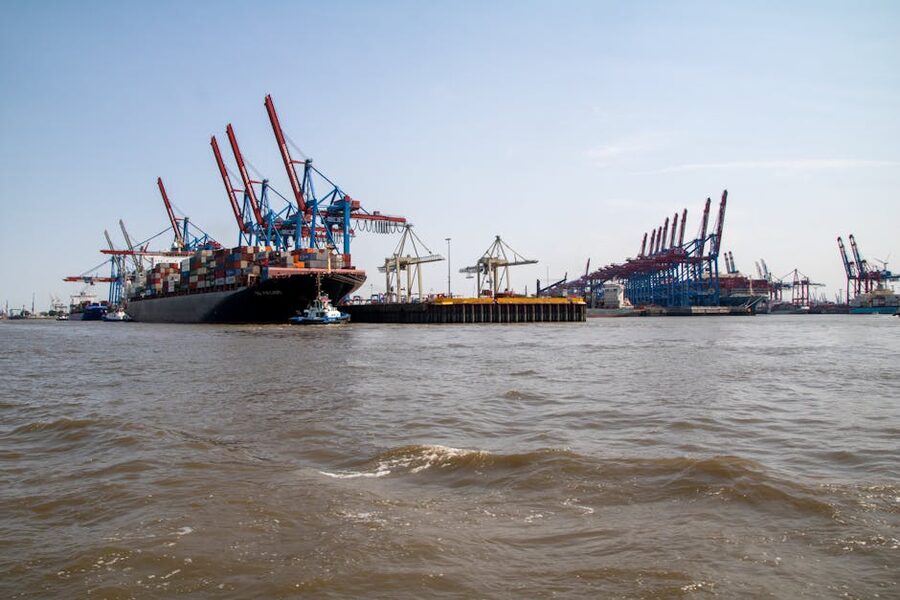 Container ship at Hamburg port with cranes