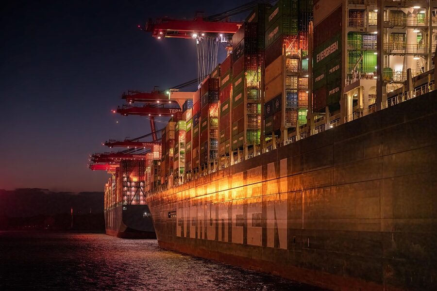 Hamburg port at night with container ships and floodlights