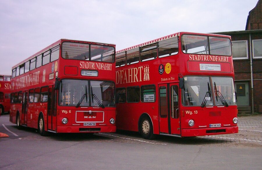 Red double-decker hop-on hop-off buses parked in Hamburg