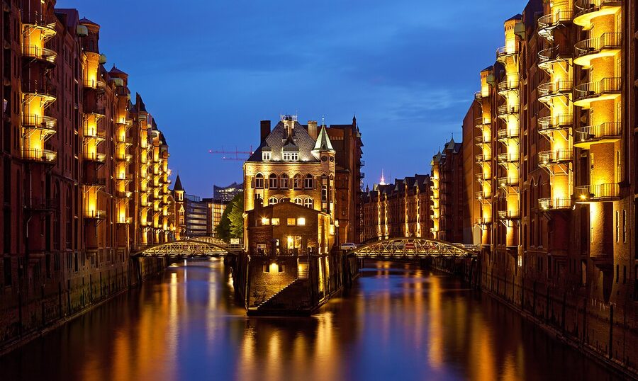 Speicherstadt at evening from Poggenmuhlenbrucke with reflections in canal