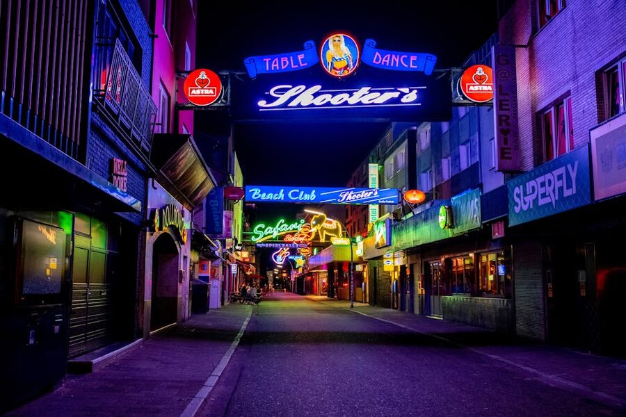 Reeperbahn at night with neon-lit storefronts in Hamburg St Pauli