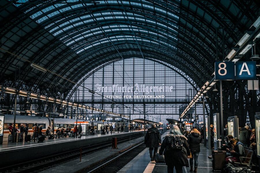 Inside Frankfurt Hauptbahnhof main hall with travellers and trains