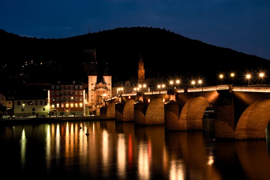 Heidelberg Alte Bruecke and castle reflected in Neckar at night
