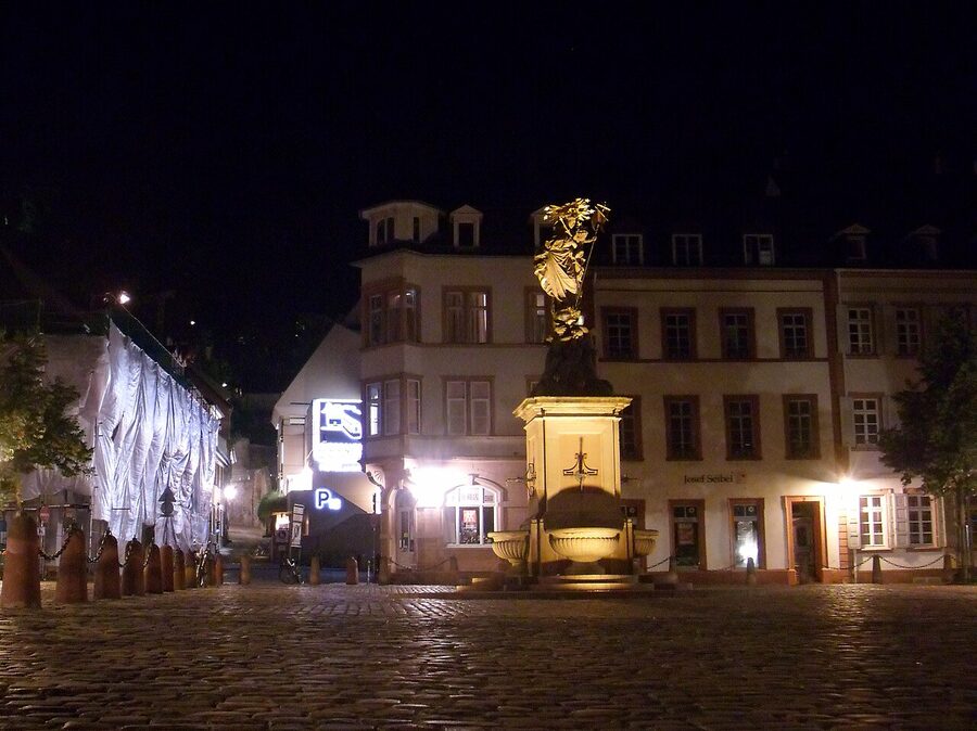 Heidelberg Altstadt corner at night with warm lamp light