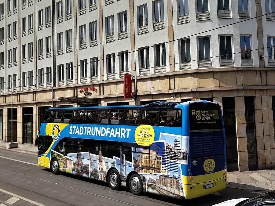 Leipzig Stadtrundfahrt sightseeing bus passing through the city center