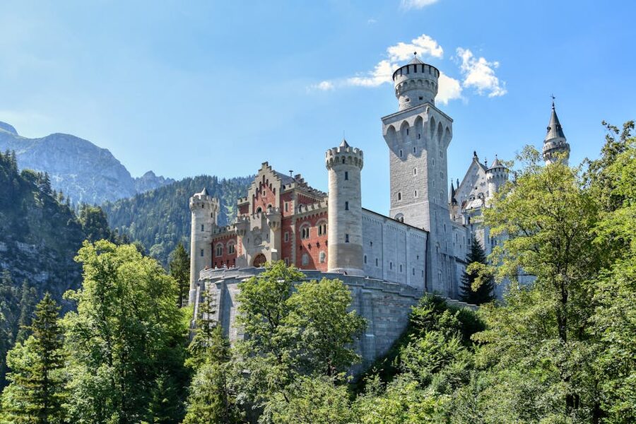 Neuschwanstein Castle surrounded by summer greenery