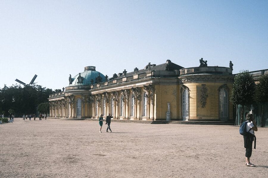 Sanssouci Palace front facade Potsdam with visitors arriving
