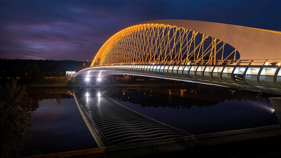 Prague bridge over Vltava with reflection at night