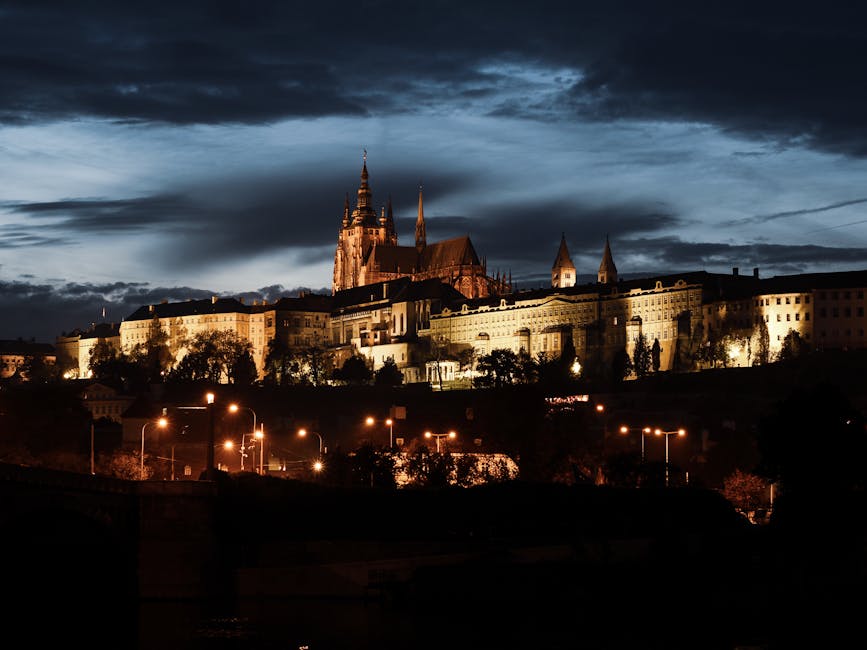 Prague Castle illuminated at night with church spires