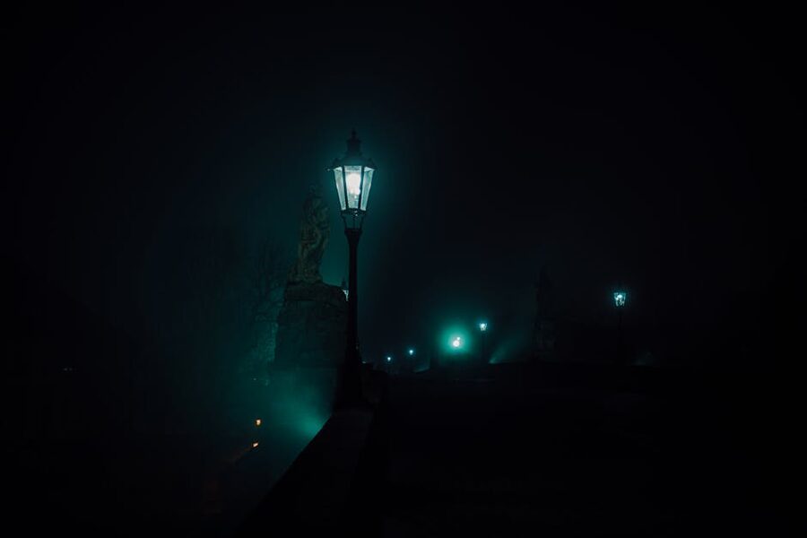 Charles Bridge street lamps glowing at night Prague