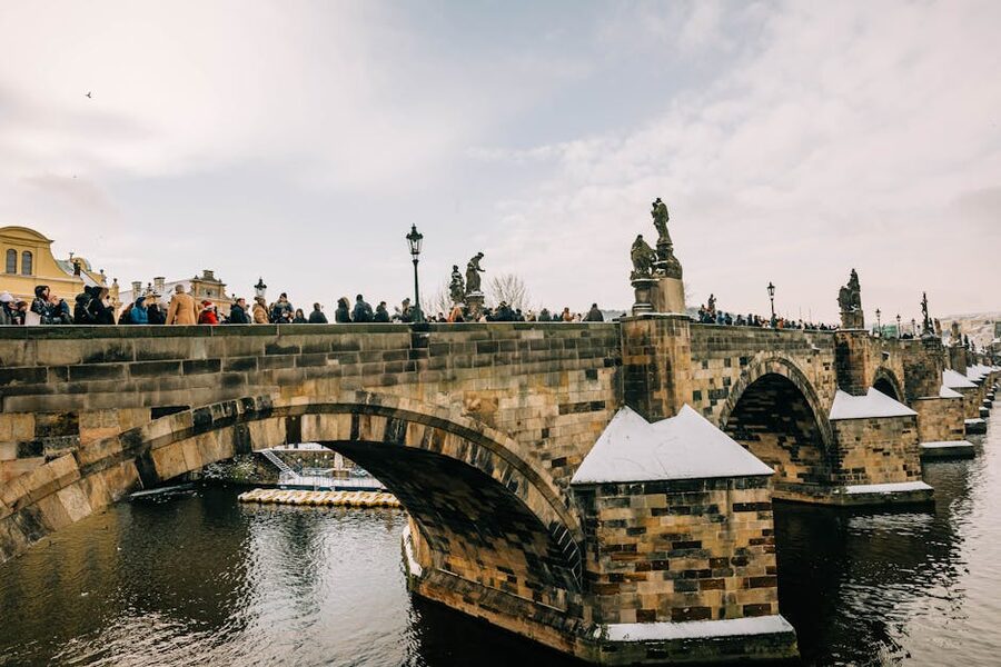 Tourists walking across Charles Bridge in Prague winter
