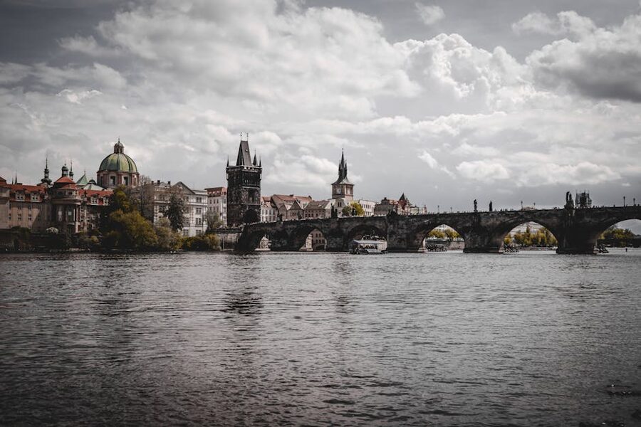 Charles Bridge spanning Vltava River with Prague skyline