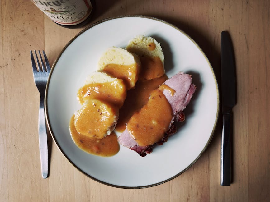 Traditional Czech dumplings and pork with sauce on plate