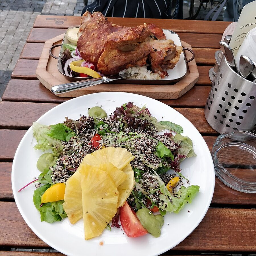 Czech roast pork knee koleno on a board with sauces
