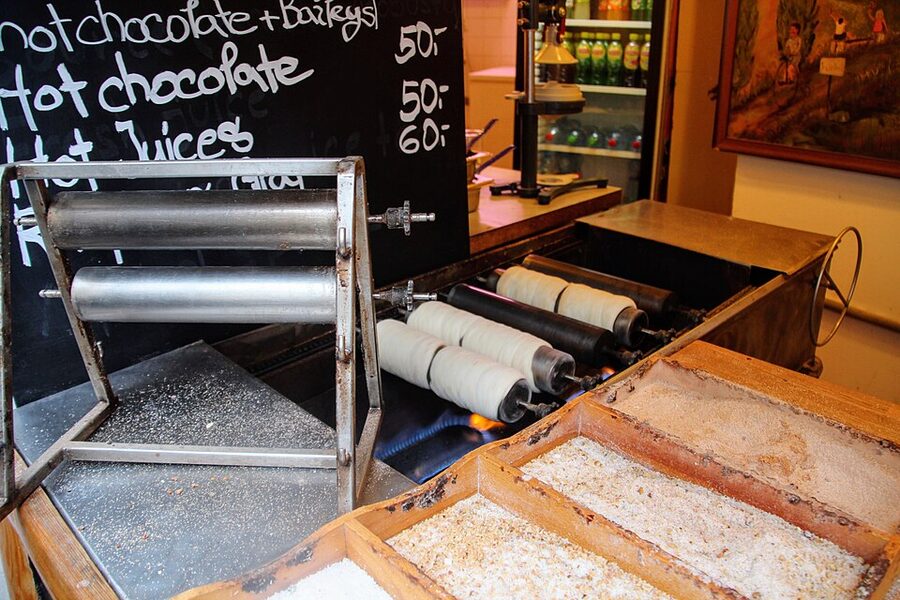 Prague trdelnik stand with finished pastries on display