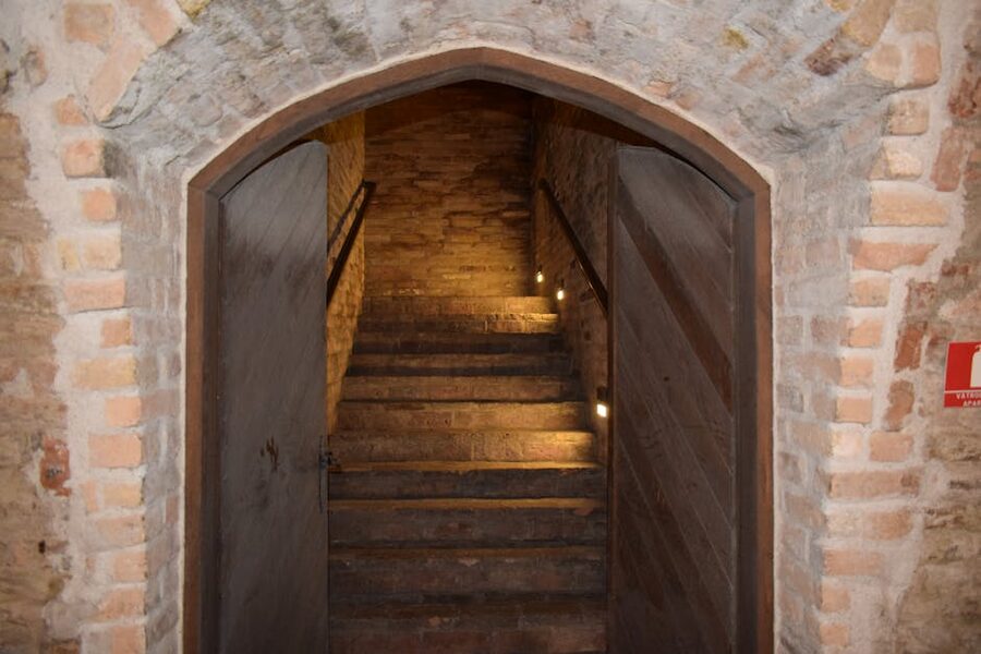 Dimly lit stone stairway descending