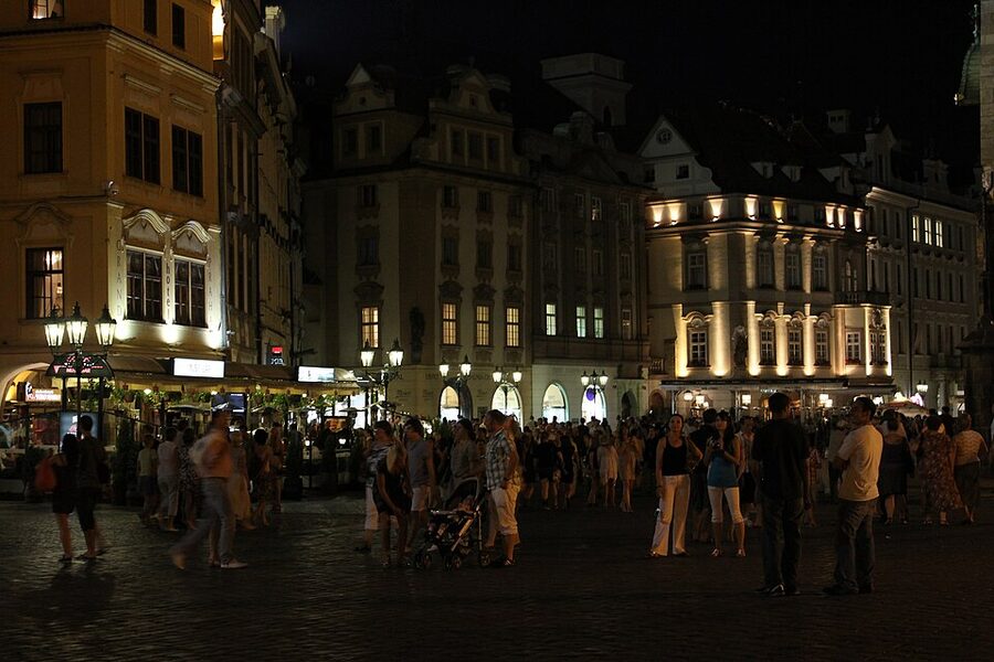 Prague Old Town lit up at night with the Old Town Hall tower
