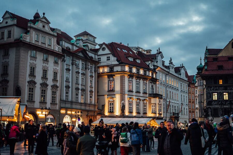 Prague Old Town Square evening crowds with illuminated buildings