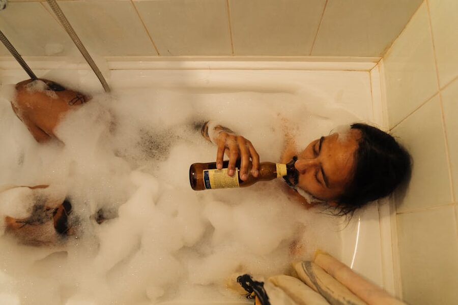 Relaxing in a beer bath with bubbles and a glass of beer at a Prague spa