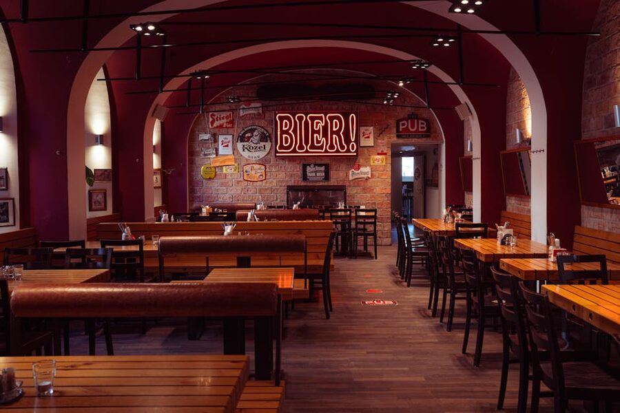 European pub interior with wooden tables and warm lighting where the Pilsner Urquell tasting happens