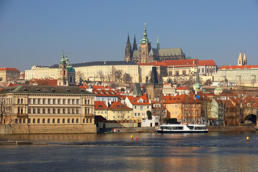 Prague Castle and Vltava panorama with cruise boat