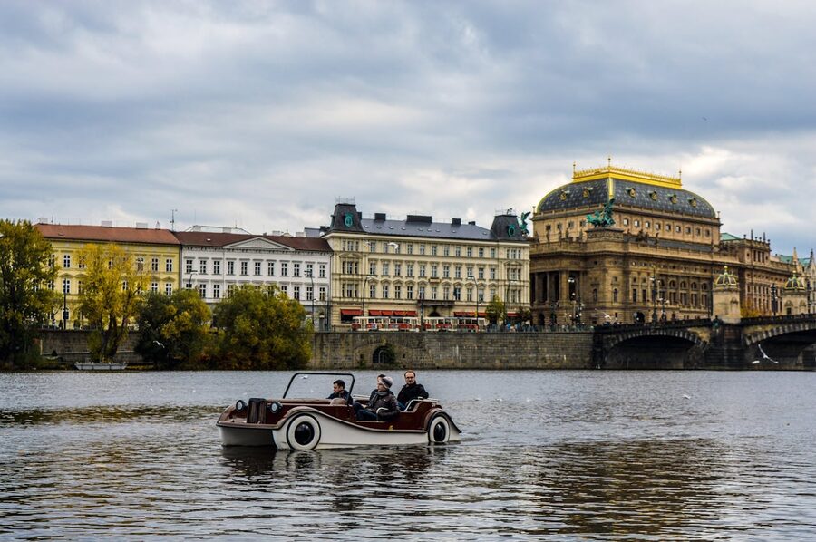 Pedal boat on the Vltava with Pragues National Theatre behind