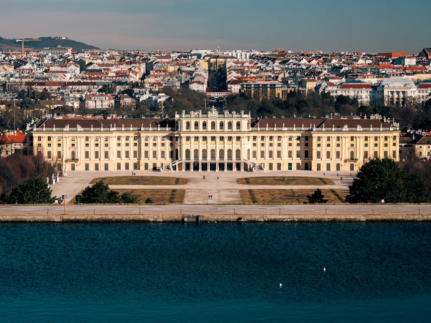 Aerial view of Schonbrunn Palace and gardens with Vienna in background