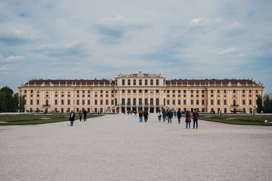 People walking in front of Schonbrunn Palace on a spring day