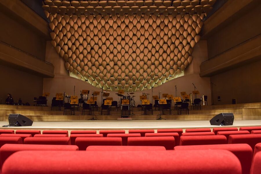 Empty concert hall with red velvet seats