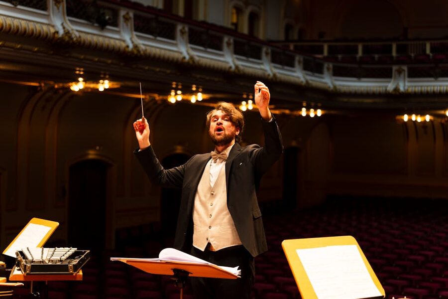 Orchestra conductor leading classical concert performance