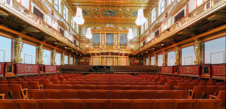 Musikverein Golden Hall interior with rows of red seats and gold stucco