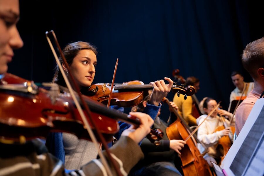 Classical orchestra performance with violinist in focus during a concert
