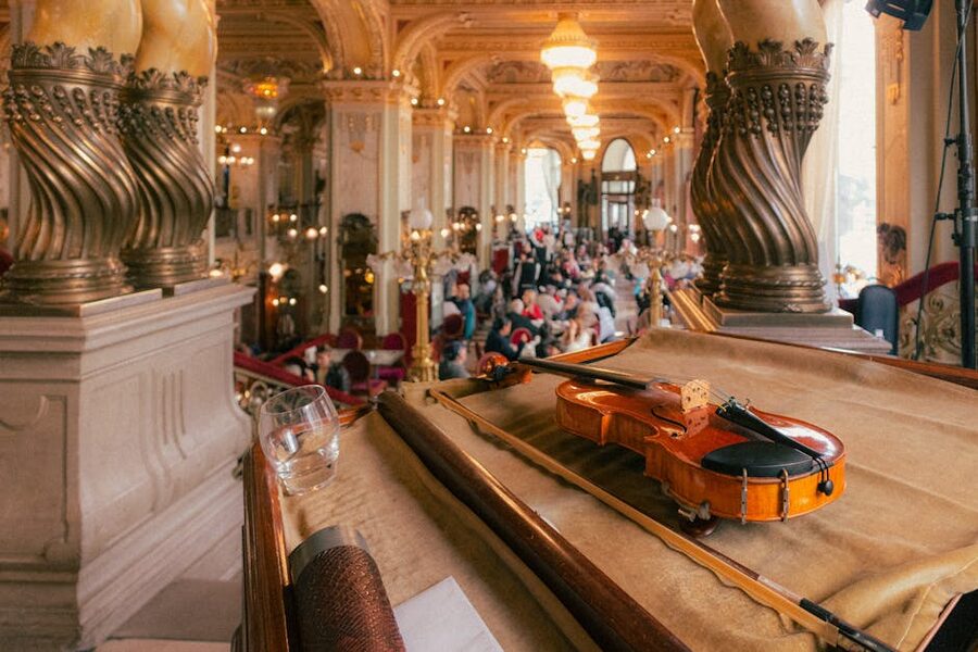 Violin resting on seat in opulent classical concert hall