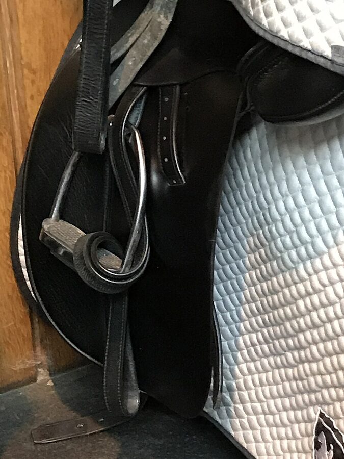 Saddle storage detail with name pegs