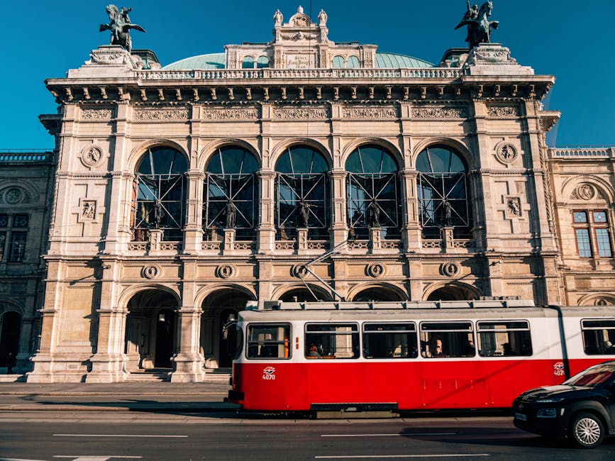 Vienna State Opera House with a red tram passing by