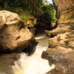 Beji Guwang Hidden Canyon Trekking Experience in Bali - The guide leads you through slippery stone and deep crossings