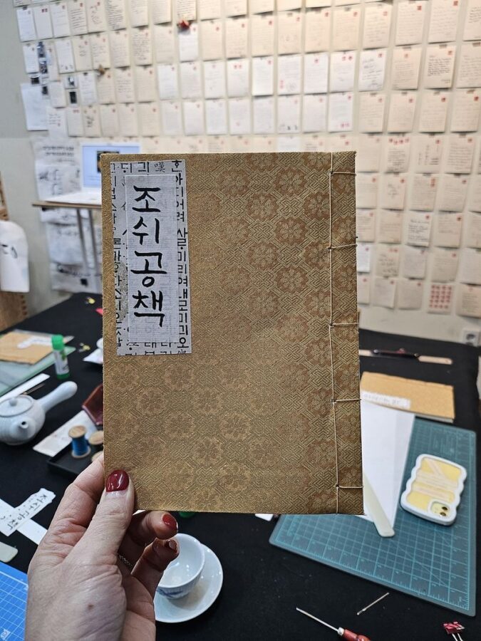 Create a Handmade Traditional Korean Notebook in Insadong - Folding, arranging, and binding the pages