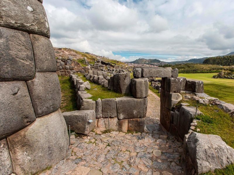 Cusco Sacsayhuamán Half-Day Cultural Tour - Sacsayhuamán: stone walls and a city view