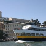 Escape from the Rock Cruise around Alcatraz Island - Alcatraz from the water, with stories attached