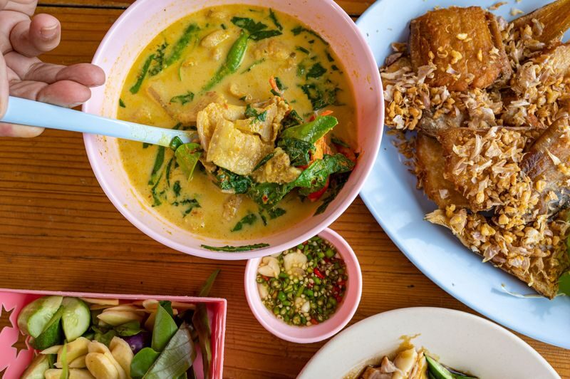 Half-Day Hidden Gems Food Experience - Riding between restaurants by Songthaew