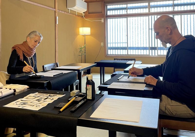 Hands-on Zen Calligraphy & 150-Year-Old Kyoto Machiya Tour - Grinding ink before making a mark