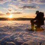 Ice Fishing Lapland Experience from Rovaniemi - Drilling through the ice and waiting for a bite