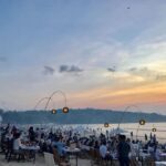Jimbaran Seafood Dining and Sunset Experience - A beach table, a seafood spread, and a changing sky