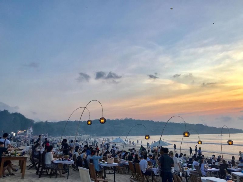 Jimbaran Seafood Dining and Sunset Experience - A beach table, a seafood spread, and a changing sky