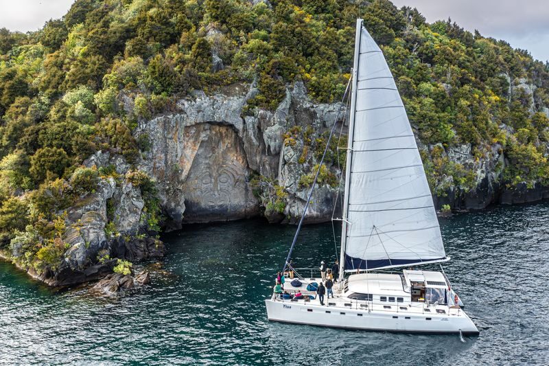 Maori Rock Carvings Taupo - Luxury Sailing Catamaran Tiua - Seeing the Maori carvings from the water