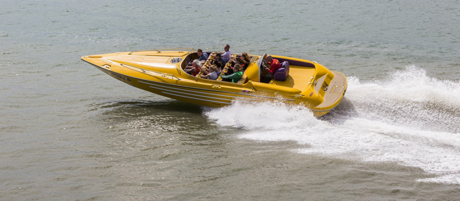 An image showcasing a turquoise speedboat gliding through crystal-clear waters towards the breathtaking Khai Islands